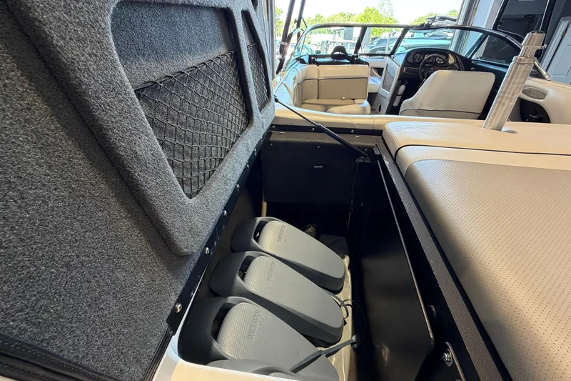 Slide: The Image of 2003 Malibu Wakesetter 21 VLX interior showing storage compartment and seating area. - 6