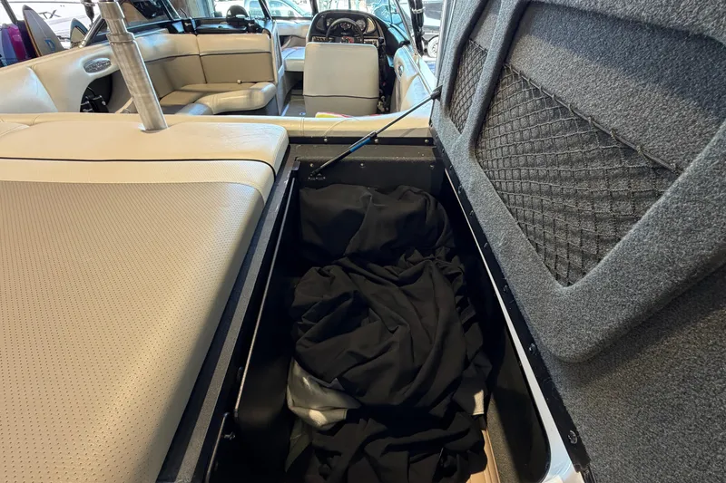 Slide: The Image of Interior of a 2003 Malibu Wakesetter 21 VLX boat with open storage compartment. - 7