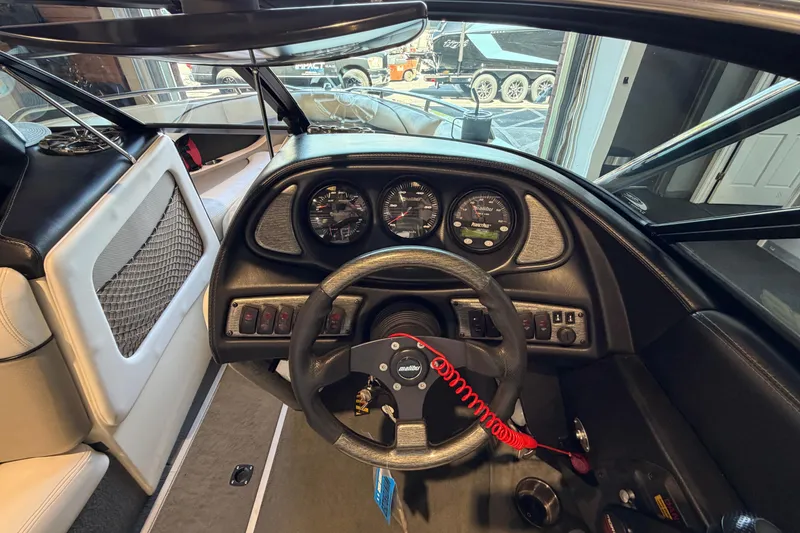Slide: The Image of 2003 Malibu Wakesetter 21 VLX boat dashboard with steering wheel and instrument panel. - 8