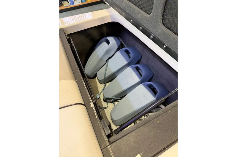 Slide: The Image of Storage compartment in a 2003 Malibu Wakesetter 21 VLX boat with neatly arranged equipment. - 14