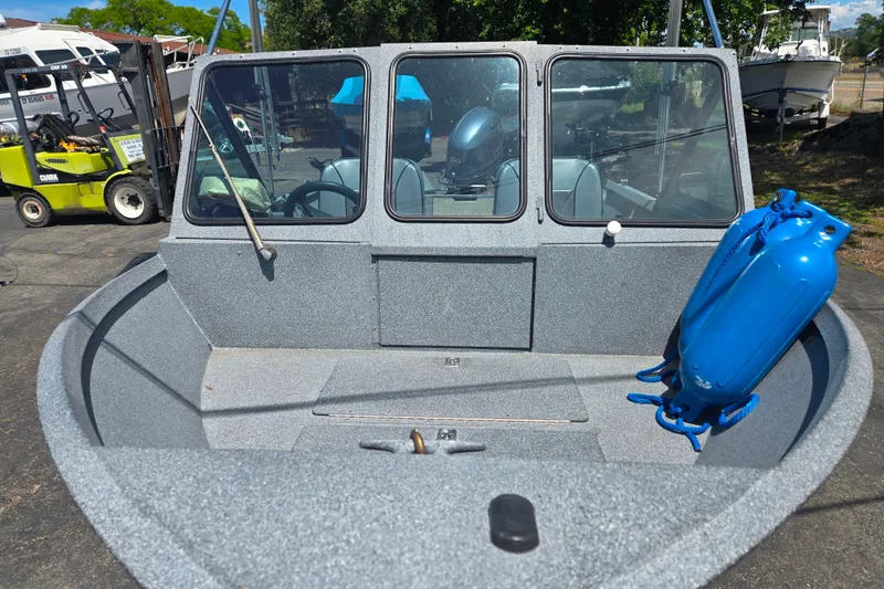 Slide: The Image of 2016 Alumaweld Talon 16 boat with blue fenders, parked outdoors. - 10