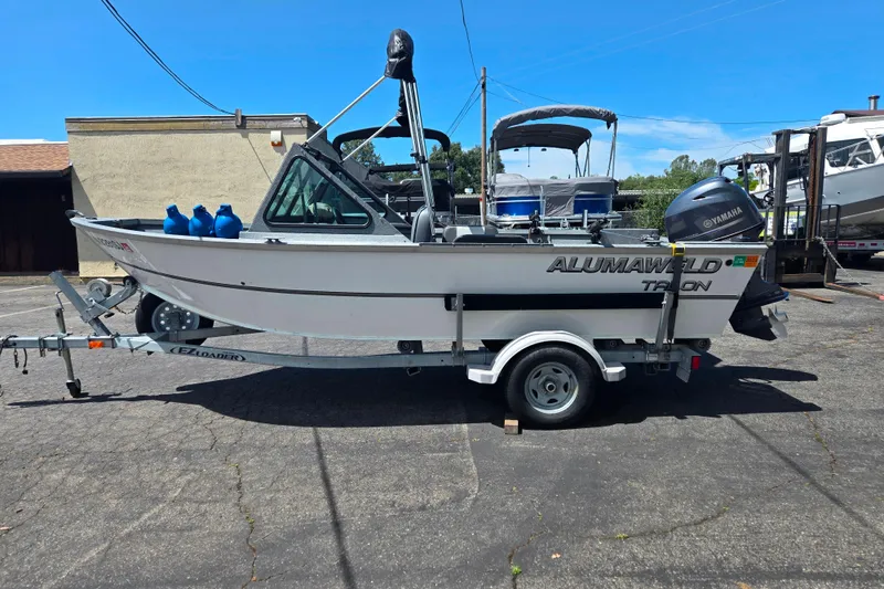 Slide: The Image of 2016 Alumaweld Talon 16 boat on trailer, parked outdoors with Yamaha motor. - 11