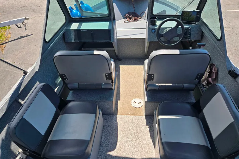 Slide: The Image of Interior of a 2016 Alumaweld Talon 16 boat with seating and steering console. - 6
