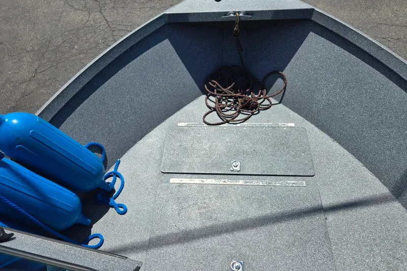 Slide: The Image of 2016 Alumaweld Talon 16 boat interior with blue fenders and coiled rope. - 7