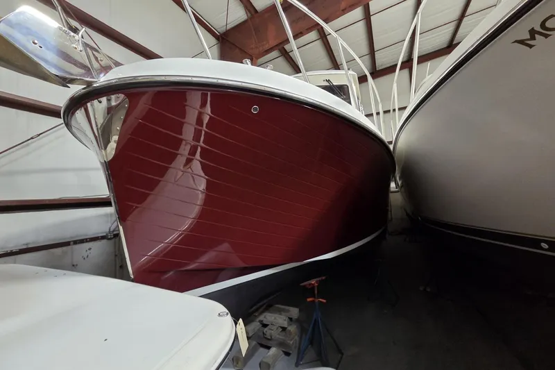 Slide: The Image of 2006 American Tug 34 Pilothouse Trawler with red hull in storage. - 10