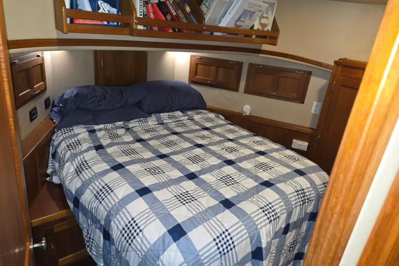Slide: The Image of Cozy cabin bedroom in 2006 American Tug 34 Pilothouse Trawler with plaid bedding. - 11
