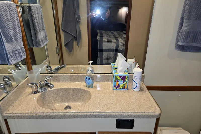 Slide: The Image of Bathroom vanity in 2006 American Tug 34 Pilothouse Trawler with towels and toiletries. - 16