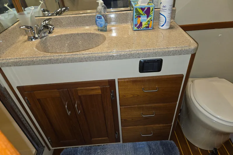 Slide: The Image of Bathroom vanity in 2006 American Tug 34 Pilothouse Trawler with sink, storage, and toilet. - 17