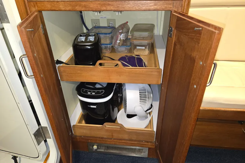 Slide: The Image of Cabinet storage in 2006 American Tug 34 Pilothouse Trawler with appliances and containers. - 23