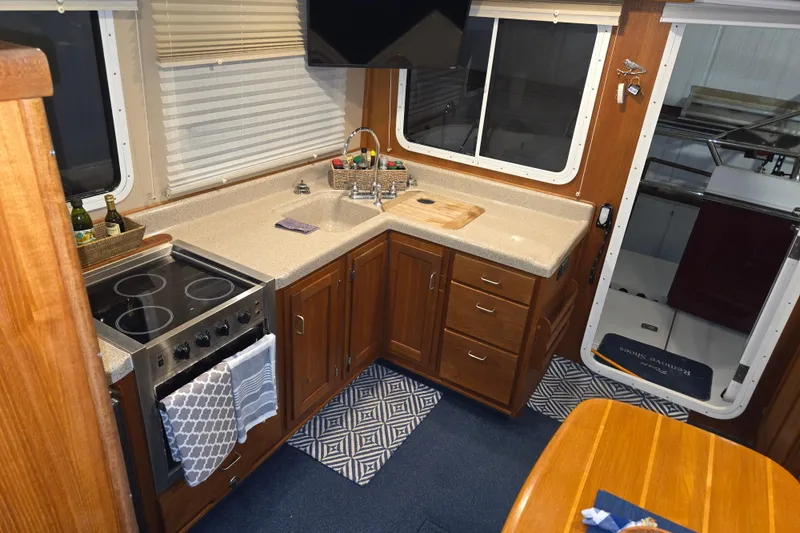Slide: The Image of Interior of 2006 American Tug 34 Pilothouse Trawler with modern kitchen amenities. - 24