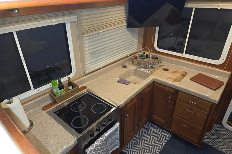 Slide: The Image of Interior of 2006 American Tug 34 Pilothouse Trawler kitchen with stove and sink. - 3