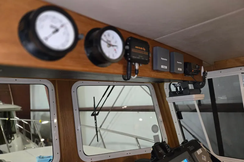 Slide: The Image of Interior of 2006 American Tug 34 Pilothouse Trawler with navigation instruments. - 33