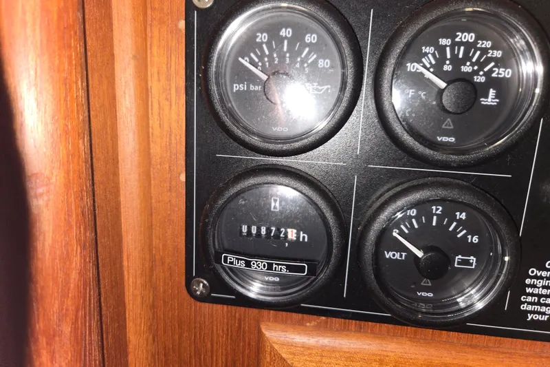Slide: The Image of Instrument panel of a 2006 American Tug 34 Pilothouse Trawler showing gauges and hours. - 35