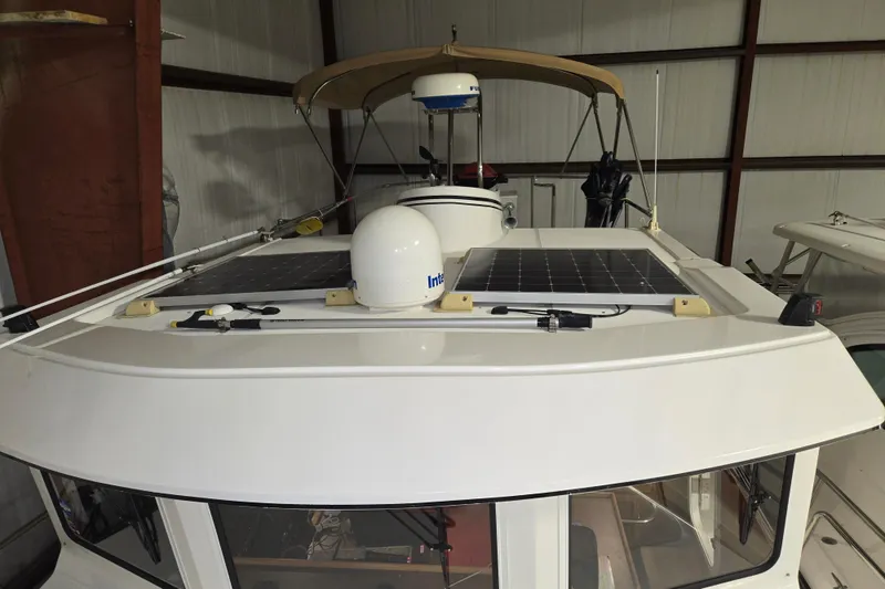 Slide: The Image of 2006 American Tug 34 Pilothouse Trawler with solar panels on the roof in storage. - 45