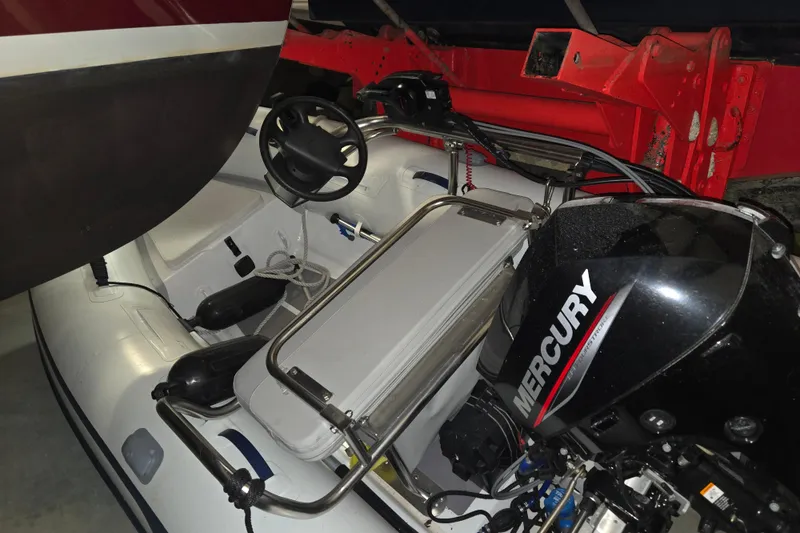 Slide: The Image of Inflatable boat with Mercury outboard motor, near 2006 American Tug 34 Pilothouse Trawler. - 54