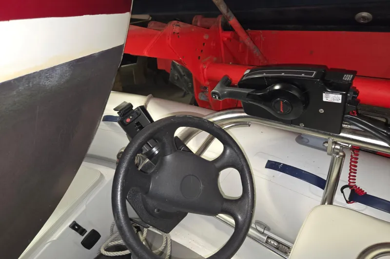 Slide: The Image of Steering wheel and controls of a 2006 American Tug 34 Pilothouse Trawler. - 56