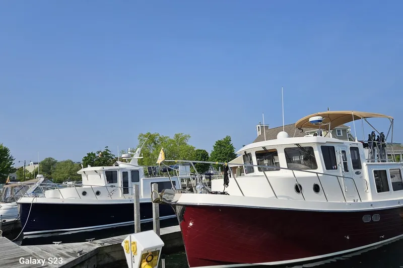 Slide: The Image of 2006 American Tug 34 Pilothouse Trawler docked at marina under clear blue sky. - 59