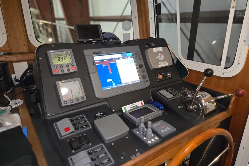 Slide: The Image of Pilothouse dashboard of 2006 American Tug 34 Pilothouse Trawler with navigation equipment. - 8