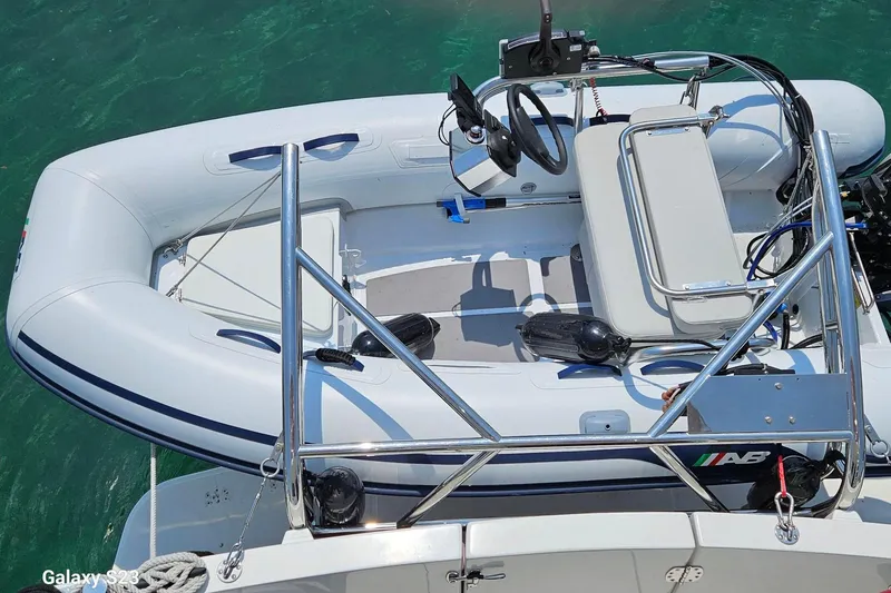 Slide: The Image of Inflatable dinghy on 2006 American Tug 34 Pilothouse Trawler, floating in clear water. - 9
