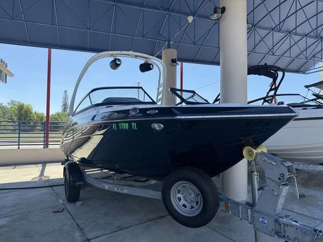 Slide: The Image of 2023 Yamaha Boats 195S on a trailer under a canopy. - 20