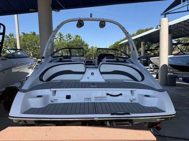 Slide: The Image of Rear view of a 2023 Yamaha Boats 195S outdoors. - 26