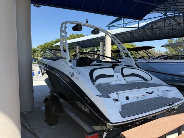Slide: The Image of 2023 Yamaha Boats 195S on a trailer outdoors. - 27