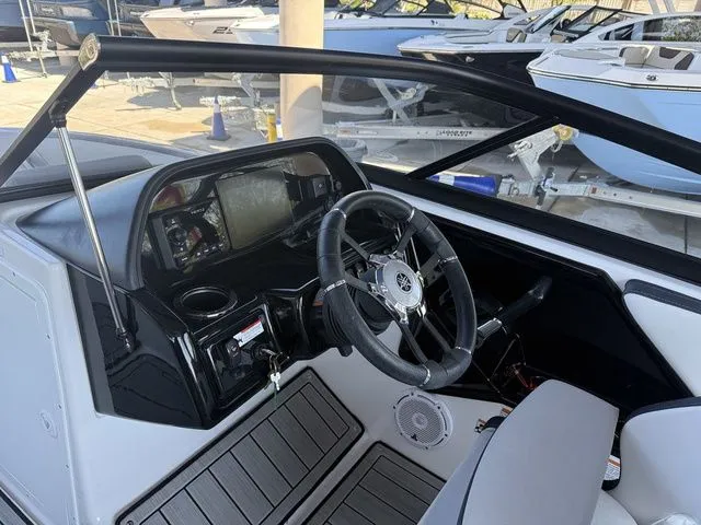 Slide: The Image of Interior view of 2023 Yamaha Boats 195S cockpit with steering wheel and dashboard. - 34