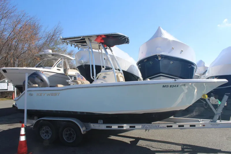 The Image of 2017 Key West 203 FS boat on trailer, parked outdoors with other boats. - 0