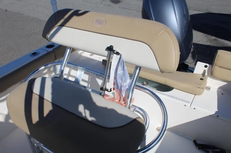 Slide: The Image of 2017 Key West 203 FS boat interior with beige seating and chrome accents. - 12