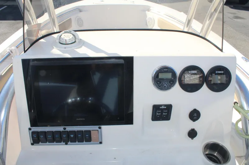 Slide: The Image of 2017 Key West 203 FS boat dashboard with Garmin display and Yamaha gauges. - 14
