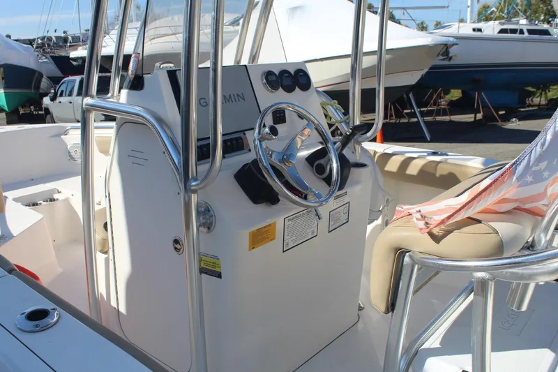 Slide: The Image of 2017 Key West 203 FS boat interior with steering wheel and American flag detail. - 5
