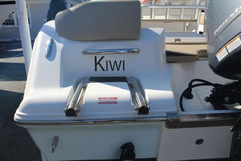 Slide: The Image of 2017 Key West 203 FS boat with "Kiwi" name and ladder, featuring a four-stroke engine. - 6
