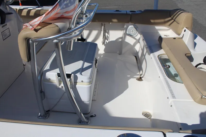 Slide: The Image of 2017 Key West 203 FS boat interior with seating, cooler, and American flag. - 7
