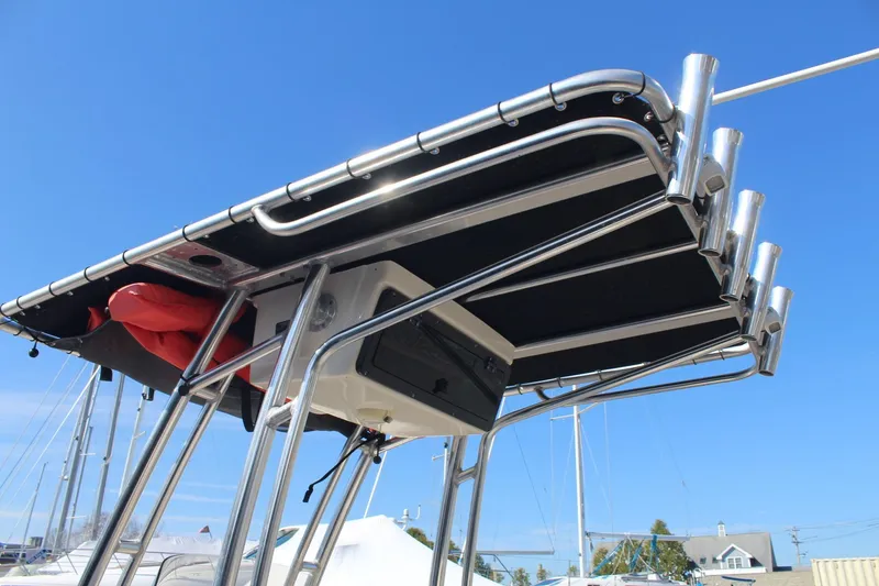 Slide: The Image of 2017 Key West 203 FS boat T-top with rod holders against clear blue sky. - 9