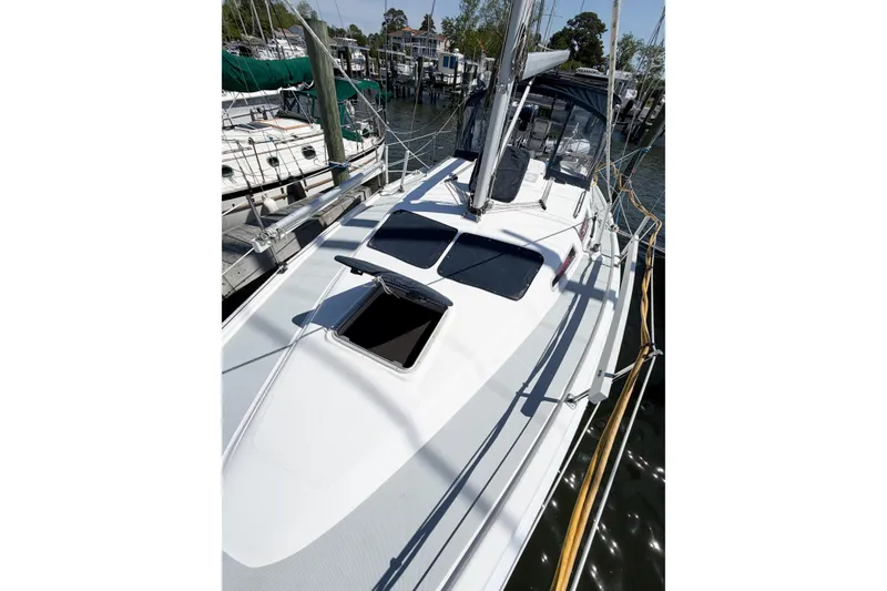 Slide: The Image of 2005 Hunter 36 sailboat docked at marina, featuring sleek deck design. - 11