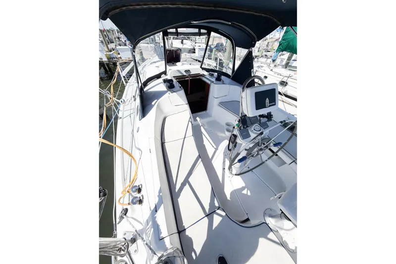 Slide: The Image of 2005 Hunter 36 sailboat cockpit with steering wheel and navigation equipment. - 15