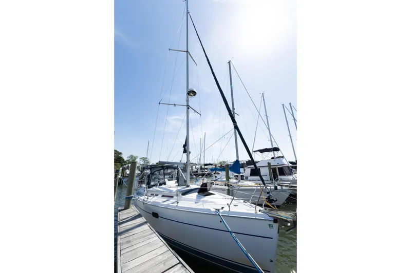 Slide: The Image of 2005 Hunter 36 sailboat docked at marina under clear blue sky. - 2