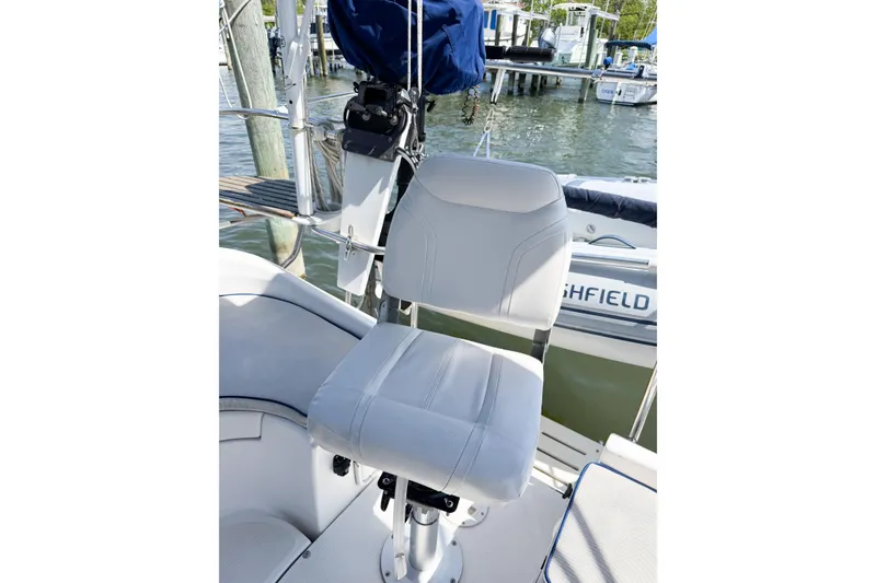 Slide: The Image of White captain's chair on a 2005 Hunter 36 sailboat, docked at a marina. - 26