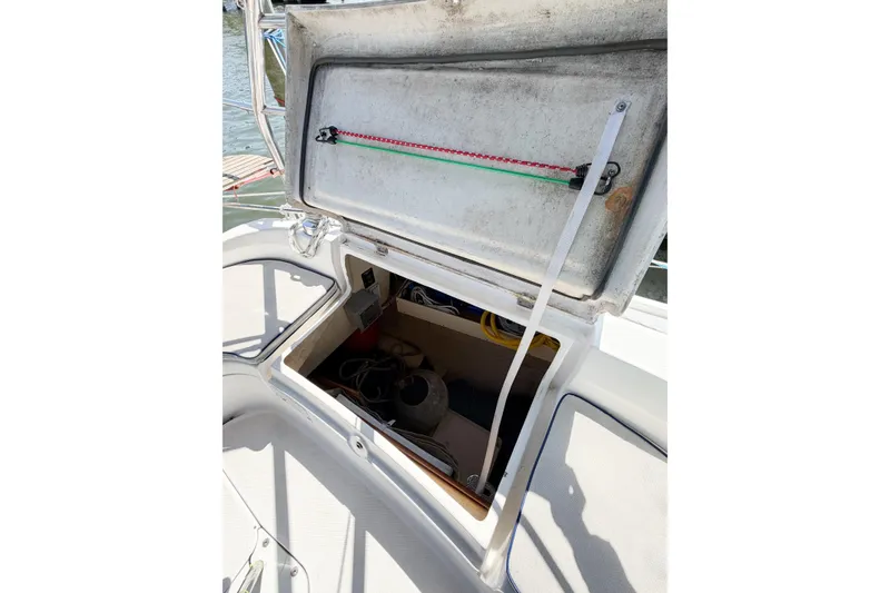 Slide: The Image of Open storage compartment on a 2005 Hunter 36 sailboat, showing interior equipment and ropes. - 28