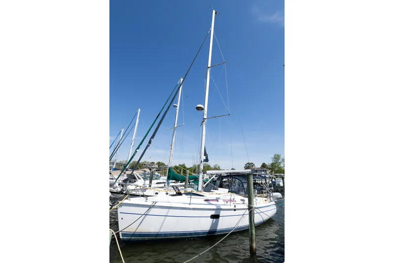 Slide: The Image of 2005 Hunter 36 sailboat docked at marina under clear blue sky. - 3