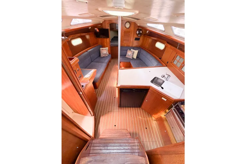Slide: The Image of Interior of 2005 Hunter 36 sailboat with wood finish and cozy seating area. - 32