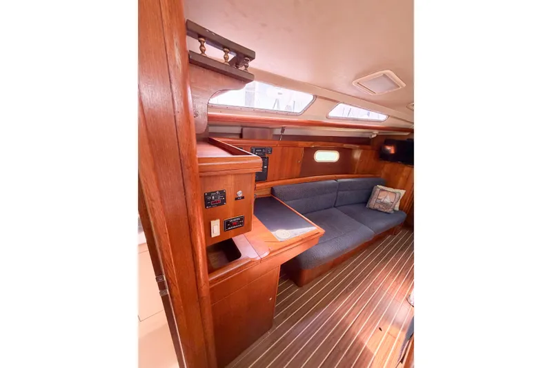 Slide: The Image of Interior of 2005 Hunter 36 sailboat with wood paneling and blue seating. - 37