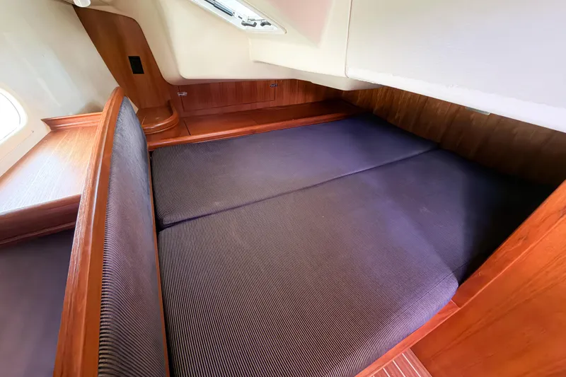 Slide: The Image of Cozy cabin interior of 2005 Hunter 36 sailboat with wooden finish and comfortable bedding. - 39