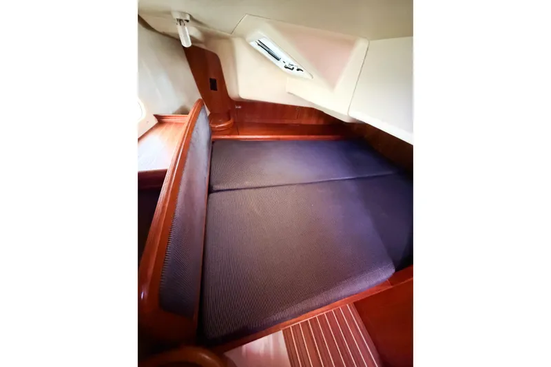 Slide: The Image of Interior cabin of a 2005 Hunter 36 sailboat with wooden finish and cushioned seating. - 40