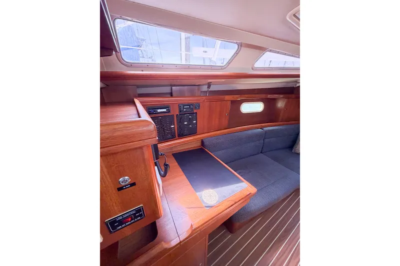 Slide: The Image of Interior of 2005 Hunter 36 sailboat with wood paneling and seating area. - 43