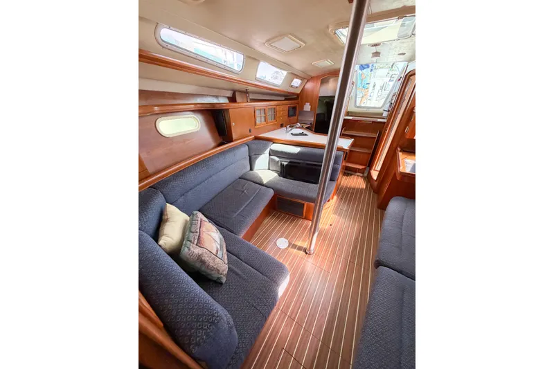 Slide: The Image of Interior of 2005 Hunter 36 sailboat with cozy seating and wooden finishes. - 45