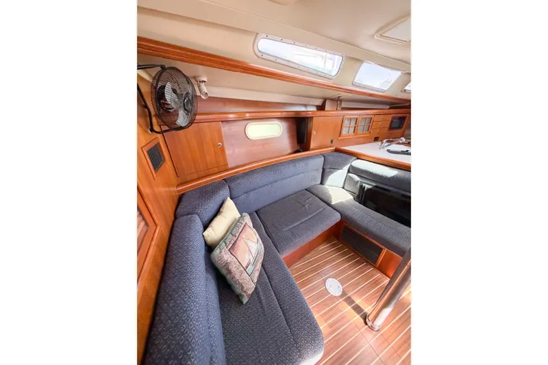 Slide: The Image of Interior of 2005 Hunter 36 sailboat with cozy seating and wooden accents. - 46