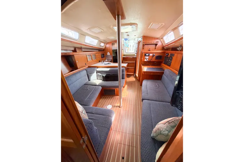 Slide: The Image of Interior of 2005 Hunter 36 sailboat with cozy seating and wooden finishes. - 47