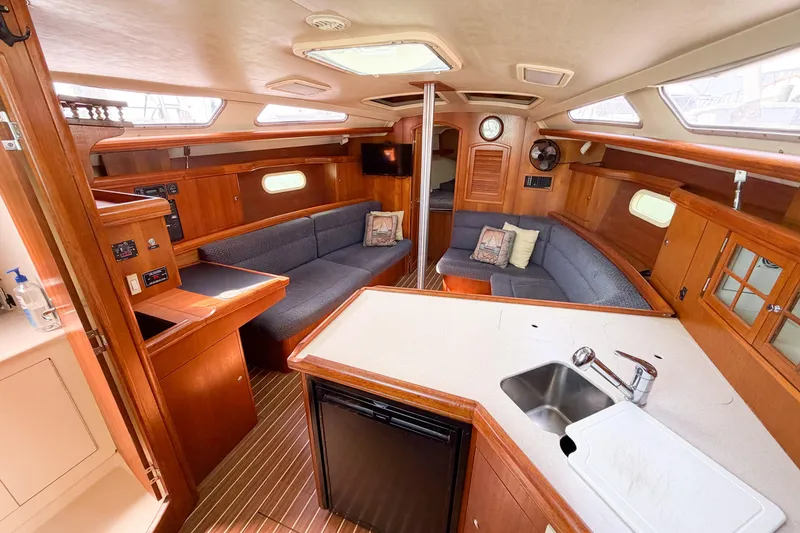 Slide: The Image of Interior of a 2005 Hunter 36 sailboat with cozy seating and wooden cabinetry. - 49