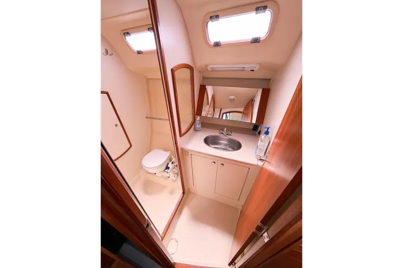 Slide: The Image of 2005 Hunter 36 yacht bathroom with sink, mirror, and toilet. - 51